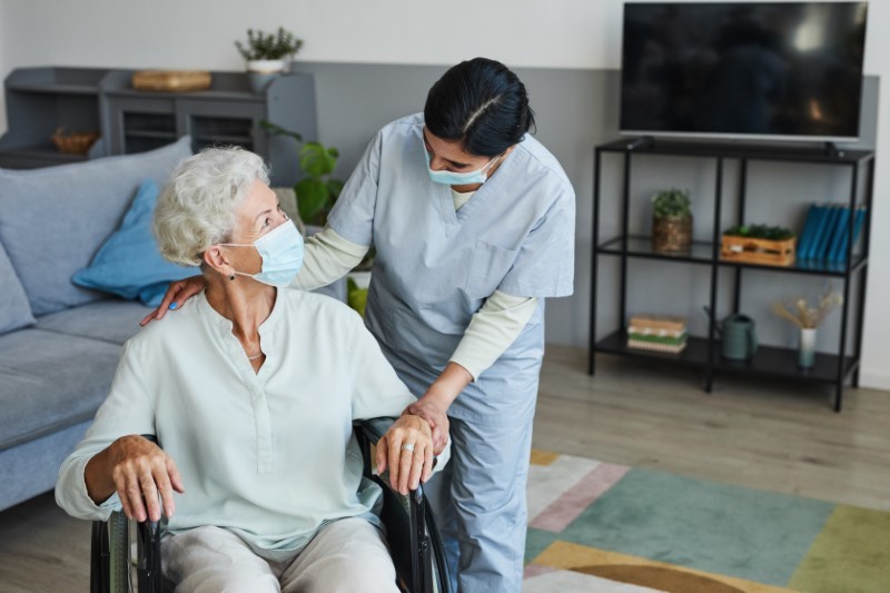 Caring Nurse Helping Senior in Wheelchair