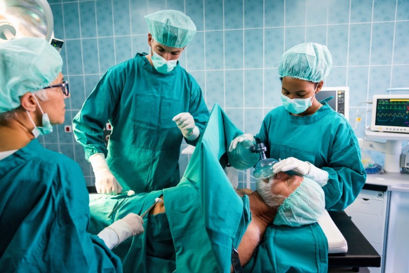 Surgery team operating in a surgical room